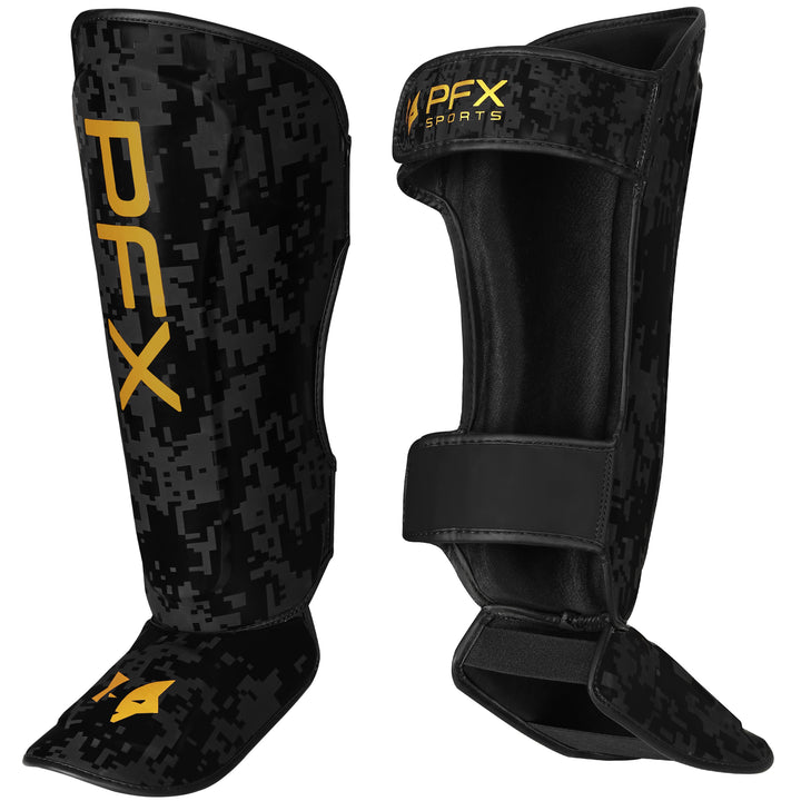 Close-up of PFX shin guard's gold accents and multi-layered foam padding, emphasizing premium impact protection and design.